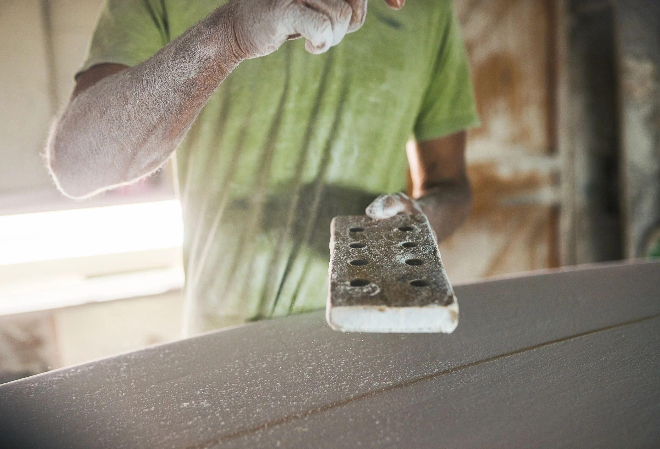 Close-up of sanding during surface preparation