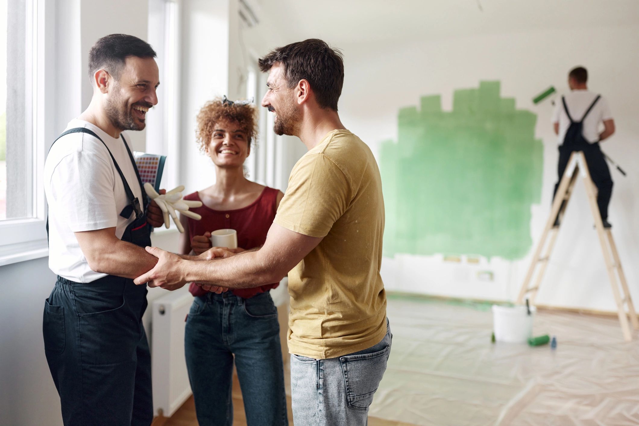 Painter discussing project details with homeowners